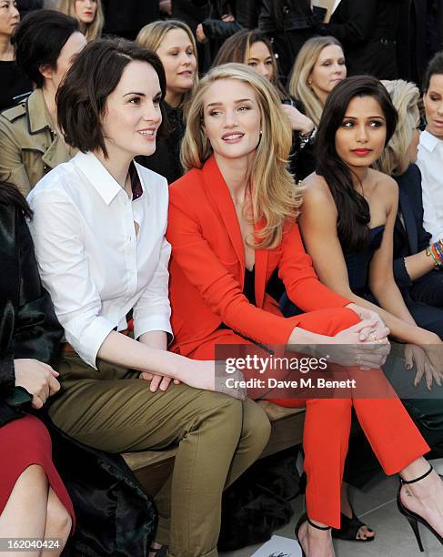 Michelle Dockery, Rosie Huntington-Whiteley and Freida Pinto sits in the front row for the Burberry Prorsum Autumn Winter 2013 Womenswear Show at...