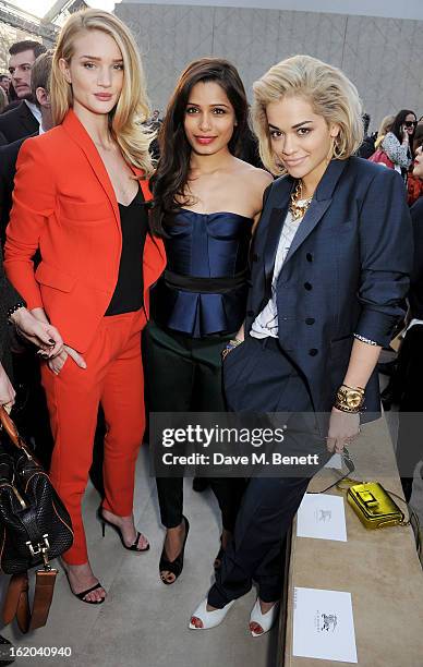Rosie Huntington-Whiteley, Freida Pinto and Rita Ora attend the Burberry Prorsum Autumn Winter 2013 Womenswear Show at Kensington Gardens on February...