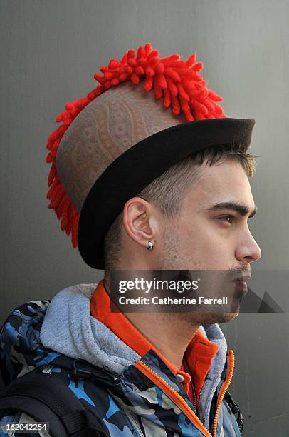 Milliner Jordan Bowen wearing his own punk inspired paisley printed heritage style hat with red cockscomb quiff at London Fashion Week Fall/Winter...