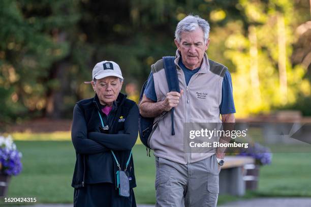 Jerome Powell, chairman of the U.S. Federal Reserve, right, and Elissa Leonard walk the grounds at the Jackson Hole economic symposium in Moran,...