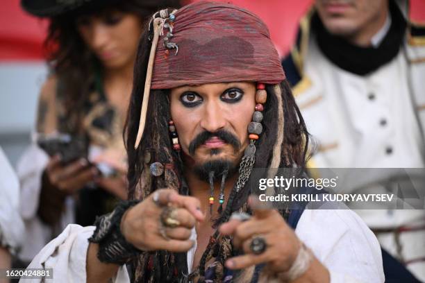Fan dressed as Captain Jack Sparrow poses for a photo in the crowd ahead of the men's long jump final during the World Athletics Championships at the...