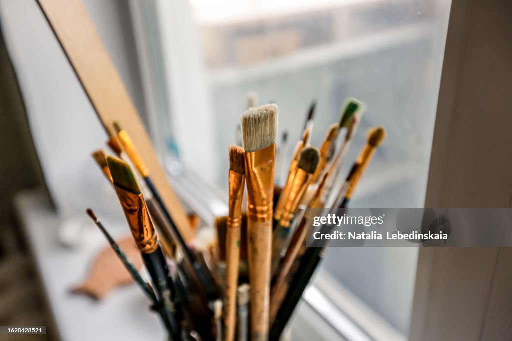 Artistic Tools: Paint Brushes Arranged in Glass, Creative Workspace