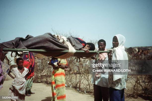 Sick child is taken away on a stretcher in Gannet refugees camp, 5 July 1985 near Hargeysa , during the Somalian Ethiopian frontier conflict. Over 60...