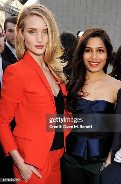 Rosie Huntington-Whiteley and Freida Pinto sit in the front row for the Burberry Prorsum Autumn Winter 2013 Womenswear Show at Kensington Gardens on...