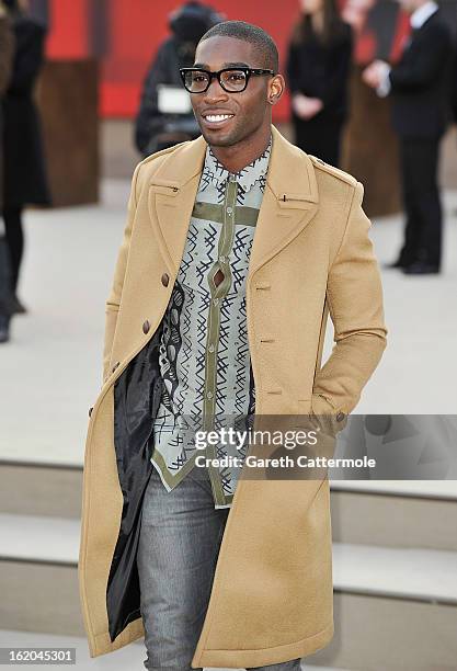 Tinie Tempah wearing Burberry, arrives at the Burberry Prorsum Autumn Winter 2013 Womenswear Show on February 18, 2013 in London, England.