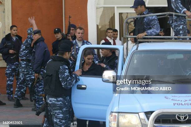 Palestinian policmen evacuate a foreign family from a hotel after militants snatched some foreigners in Gaza City, as supporters of the PFLP take to...