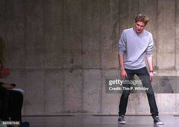 Designer Jonathan William Anderson walks the runway at the J.W. Anderson show during London Fashion Week Fall/Winter 2013/14 at TopShop Show Space on...