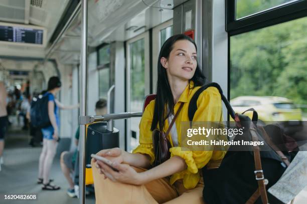 beautiful tourist traveling by bus on a trip, using online map on smartphone to check direction. - slovakia map stock pictures, royalty-free photos & images