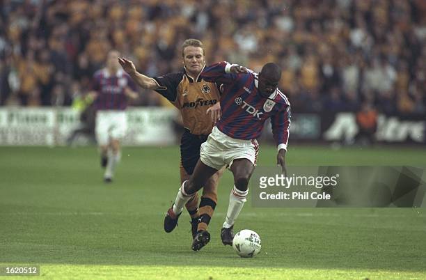 Bruce Dyer of Crystal Palace takes on Geoff Thomas of Wolverhampton Wanderers during the Division One Play Off Second Leg at Molineux in...