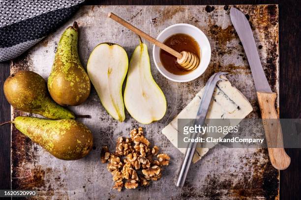 baked pears with gorgonzola and walnuts flat lay - gorgonzola stock pictures, royalty-free photos & images