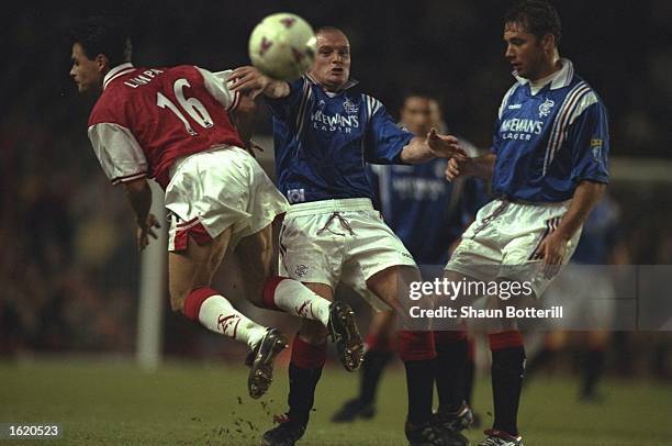 Anders Limpar playing for Arsenal is challenged by Paul Gascoigne of Glasgow Rangers with Ally McCoist of Glasgow Rangers looking on, during the...