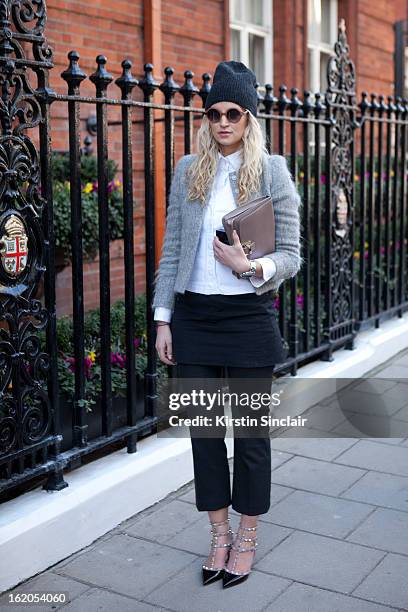 Anouk Bos wears Allsaints hat, Elizabeth and James glasses, Karen Weston jacket, Zara dress, Valentino shoes and Hulhmi clutch on day 3 of London...