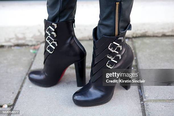 Market Editor for ELLE Magazine Bonnie Rakhit wears Christian Louboutin ankle boots on day 3 of London Womens Fashion Week Autumn/Winter 2013 on...