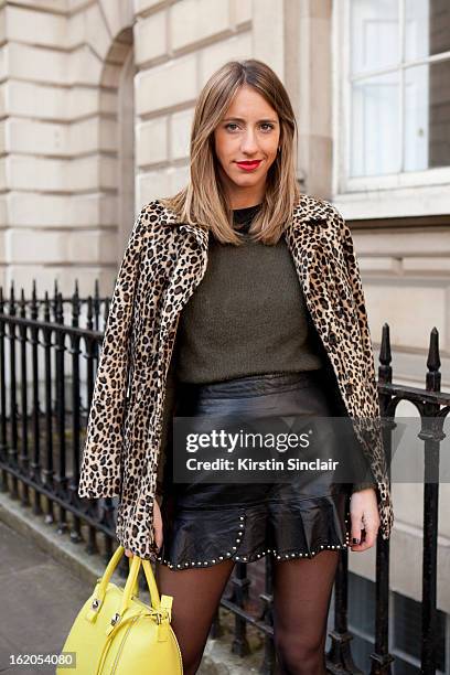 Fashion Blogger Babel Juane wears a vintage jacket, Zara top, dress, shoes and purse on day 3 of London Womens Fashion Week Autumn/Winter 2013 on...