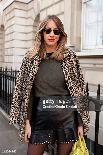 Fashion Blogger Babel Juane wears Ray-Ban sunglasses, vintage jacket, Zara top, dress and purse on day 3 of London Womens Fashion Week Autumn/Winter...