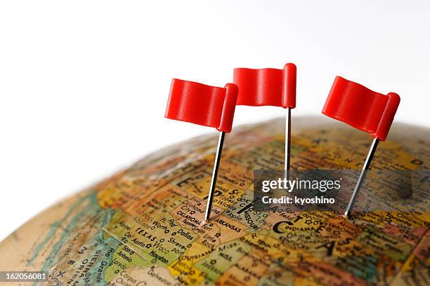 three red flag pushpin on globe against white background - progress flag stock pictures, royalty-free photos & images