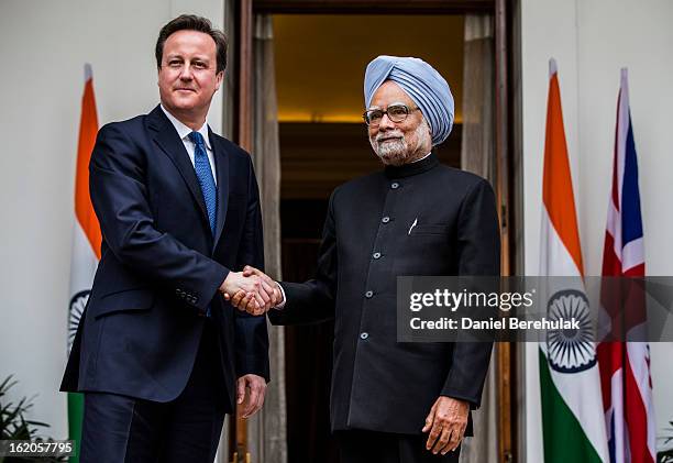 British Prime Minister David Cameron shakes hands with Indian Prime Minister Manmohan Singh at Hyderabad House on February 19, 2013 in New Delhi,...