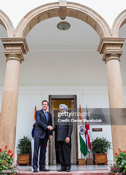 British Prime Minister David Cameron shakes hands with Indian Prime Minister Manmohan Singh at Hyderabad House on February 19, 2013 in New Delhi,...