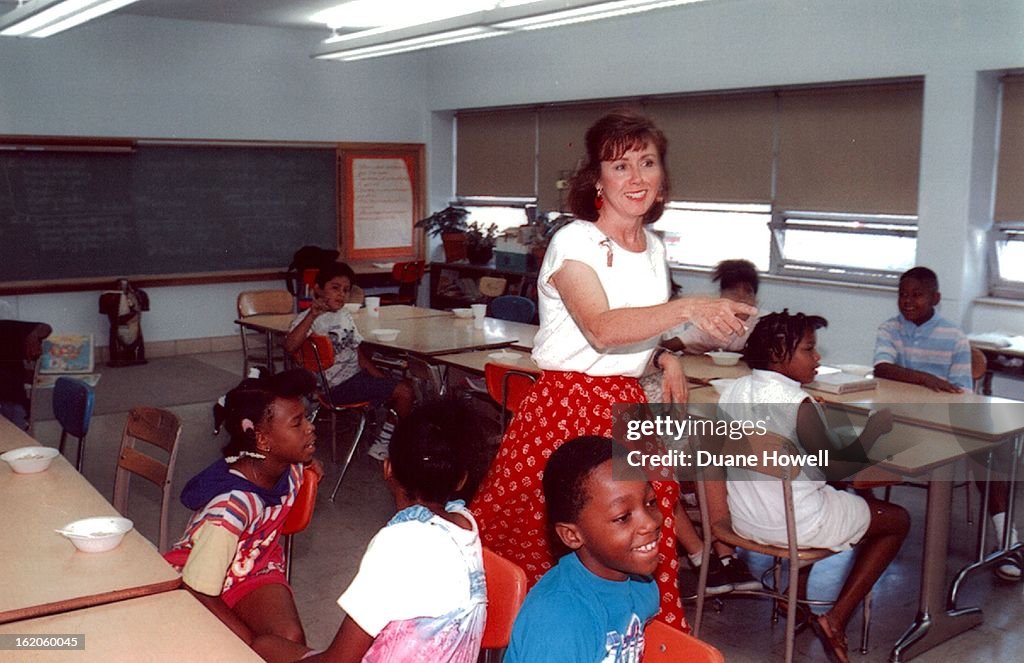 7/11/1994; Teacher Diane Theorine keeps her pupils interested and happy at Columbine.;