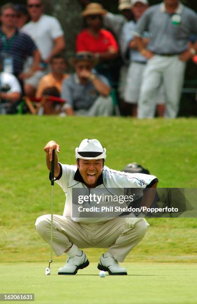 Shingo Katayama of Japan sticks out his tongue while lining up a putt during the US PGA Championship held at the Atlanta Athletic Club in Georgia,...