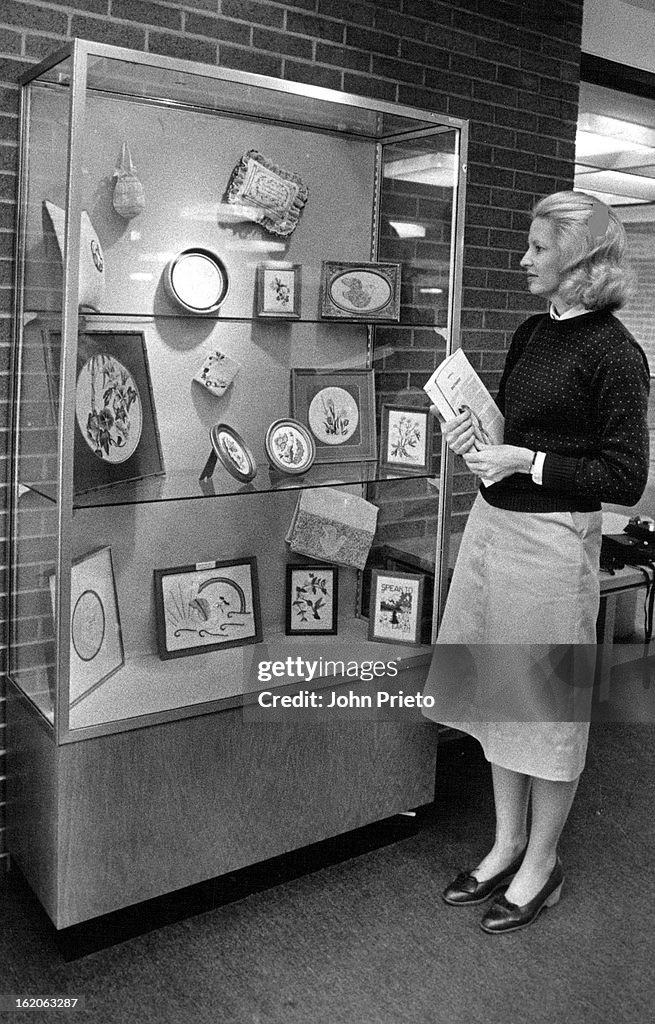 Patsy Currier JUN 2 1982; Embroidery Display; Pam Currier views an exhibit of work ...