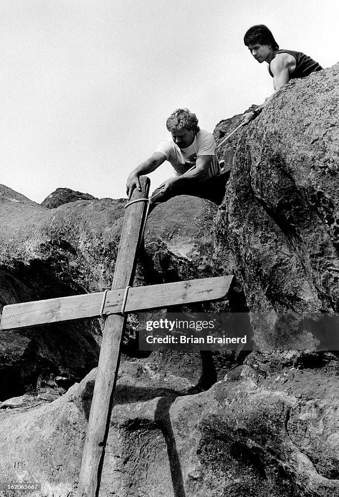 APR 19 1987; Melvin Reams (foreground) and Charles Elliott haul up one of three crosses in preparati