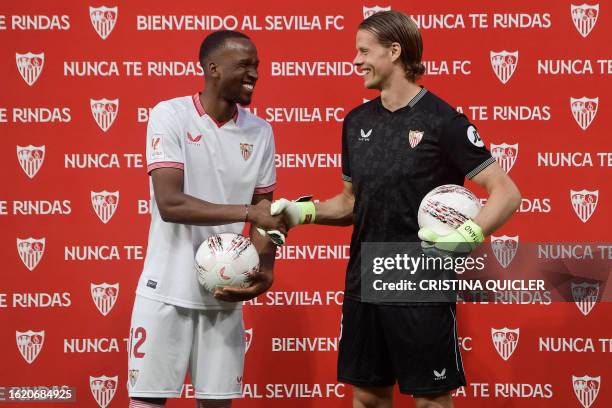 Norwegian goalkeeper Orjan Nyland and Belgian forward Dodi Lukebakio shake hands during their presentation as new players of Sevilla FC, on August...