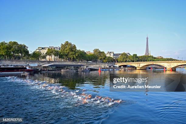 General view as athletes swim in the Seine river in front of the Eiffel Tower during the Women World Triathlon on August 17, 2023 in Paris, France.