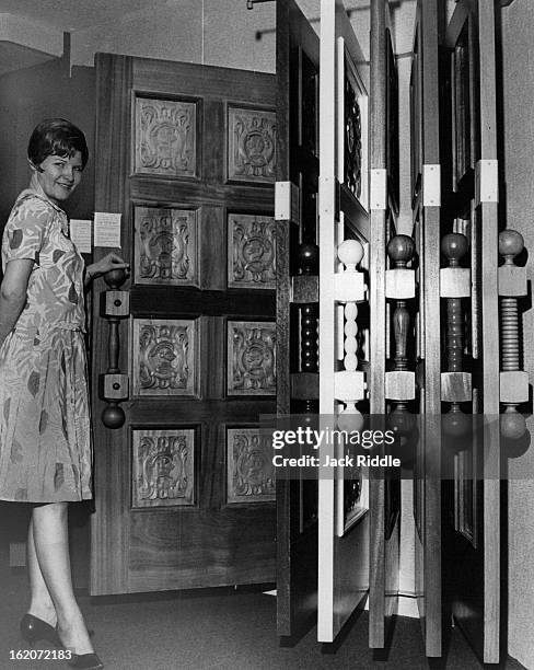 Connie Bruce shows one of some 15 door styles on display in the new Georgia Pacific "Key Room." The doors are in stock in the big warehouse, ready...