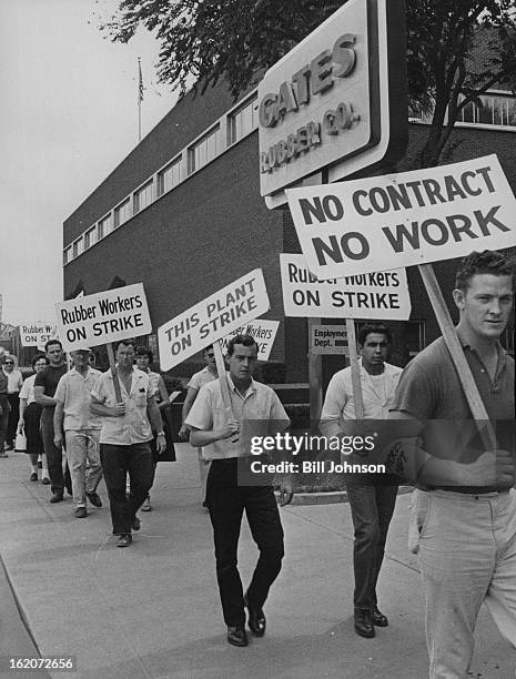 Pickets, led by their captain, Duane Donaldson of 919 Downing St., patrol the 900 block of S. Broadway where the Gates; buildings are located....