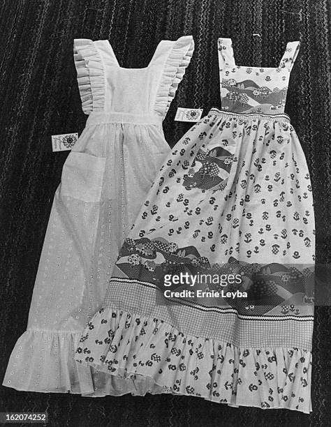 Aprons Pretty Enough For A Hoedown; The designs from Beverly Lerner's Lakewood basement include, left, a be-ruffled white eyelet apron and one with a...