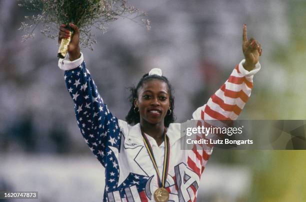 American athlete Gail Devers waves to the spectators after winning gold in the final of the women's 100 metres hurdles event at the 1992 Summer...