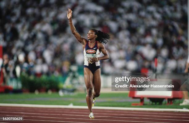 American athlete Gail Devers waves to the spectators after winning the final of the women's 100 metres event at the 1996 Summer Olympics, held at the...