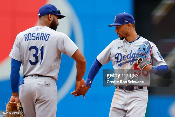 Amed Rosario and Mookie Betts of the Los Angeles Dodgers celebrate a 6-1 win against the Cleveland Guardians at Progressive Field on August 24, 2023...