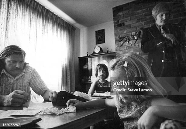 Deputy U.S. Marshal David Neff stands to the right as Newbold explains circumstances surrounding the family's eviction from their home Monday.;