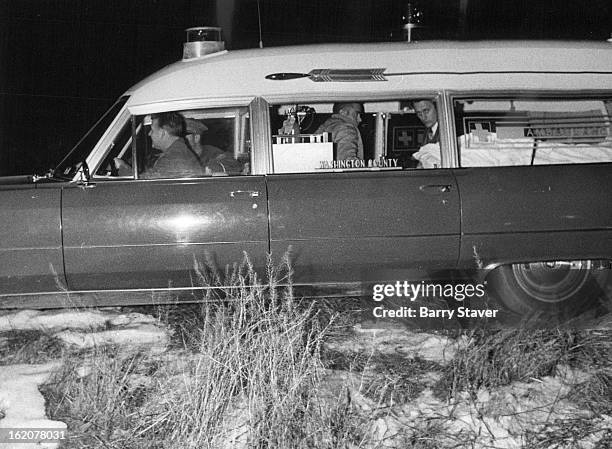 An ambulance carries hijack suspect from the scene of his arrest in a stubble field near Akron, Colo. He received sprains and bruises after bailing...