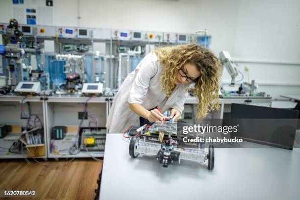 young female engineer works on new project - mechanical engineering stock pictures, royalty-free photos & images