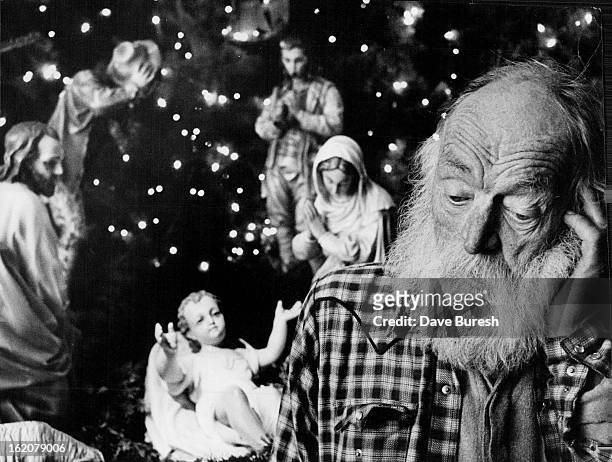 Christmas Contemplation; Frederick Schwab contemplates the nativity scene at Holy Ghost Roman Catholic Church, 19th and California streets. Schwab,...