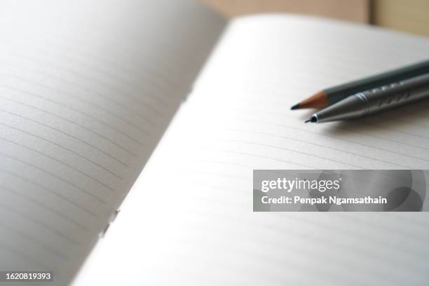 wooden pencil andmechanical pencil placed on notebook - workbook stock pictures, royalty-free photos & images