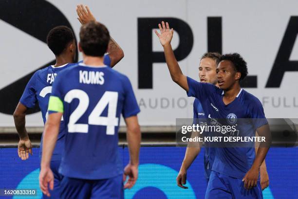 Gent's Belgian forward Malick Fofana celebrates with teammates after scoring a goal during the first leg of the play-offs for the UEFA Europa...