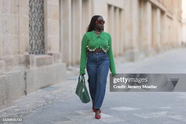 Lois Opoku seen wearing Burberry brown transparent sunglasses, gold jewelry, Milk White green knit cropped top with seashell details, Goyard green...