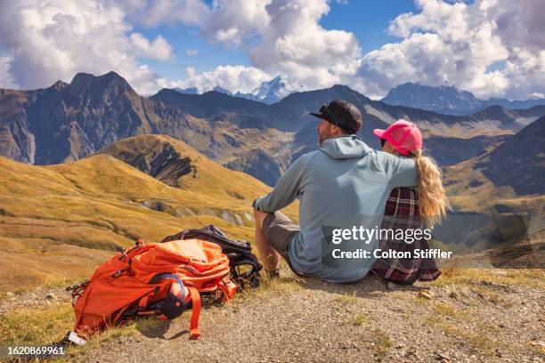 a couple enjoying the views in the swiss alps - pale complexion stock-fotos und bilder
