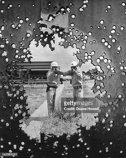 Bullet - riddled circle is the target for Ken T. Perigo, left, and James M. Askey, two recruits. They're using shotguns as part of their training to...