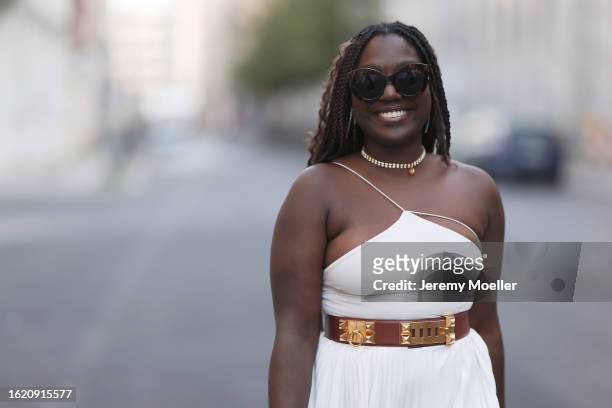 Lois Opoku seen wearing Fendi brown tortoise sunglasses, gold jewelry, H&M white off-shoulder top, Lacoste white pleated long skirt, Hermès brown...
