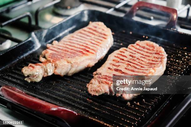 cooking steaks on a griddle pan at home - griddle stock pictures, royalty-free photos & images