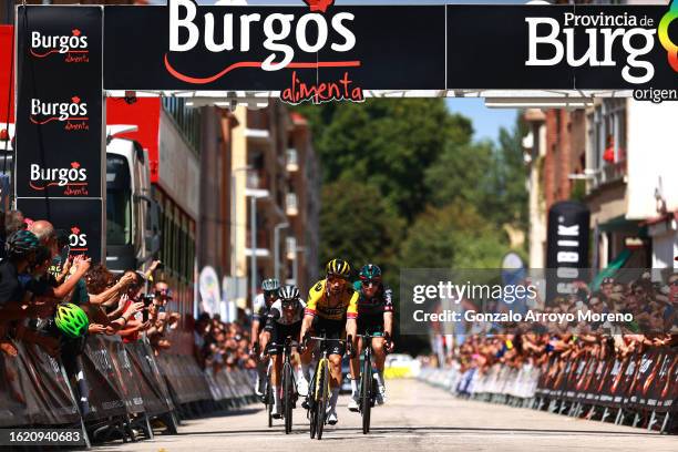 Primoz Roglic of Slovenia and Team Jumbo-Visma crosses the finish line as stage winner ahead of Adam Yates of Great Britain and UAE Team Emirates and...