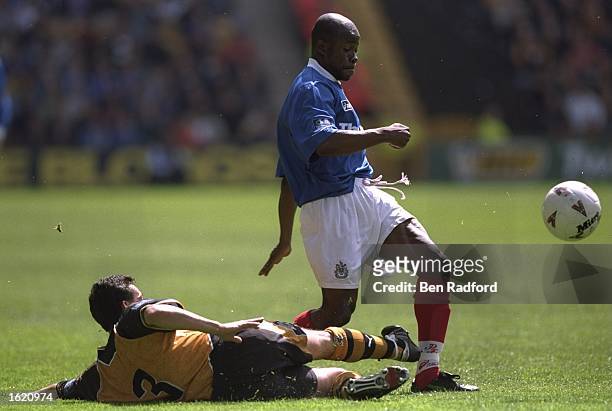 Andy Thompson of Wolverhampton Wanderers slides into tackle Paul Hall of Portsmouth during thhe Nationwide Division One match at Molineux in...