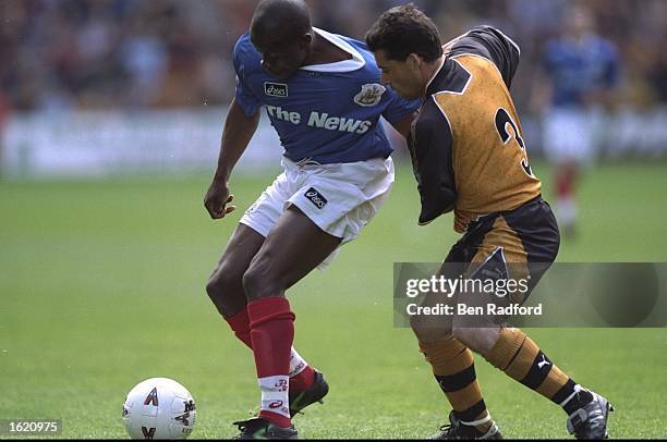 Paul Hall of Portsmouth holds off Andy Thompson of Wolverhampton Wanderers during the Nationwide Division One match at Molineux in Wolverhampton,...