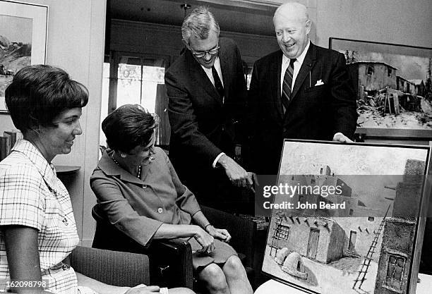 Nagel, Jerome & Mrs.; ART SALE SET AT SPALDING CENTER; Inspecting one of the oil paintings for the Art Al Fresco Sale at Spalding Rehabilitation...