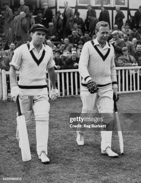 Colin McDonald and Arthur Morris of the touring Australian cricket team walk onto the field during the first innings of their match against...